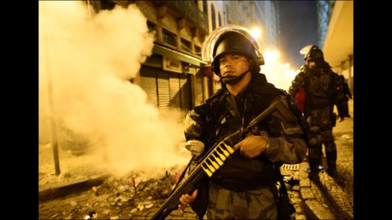 Brazilian riot cop with shotgun during clashes with protesters, June 2013.