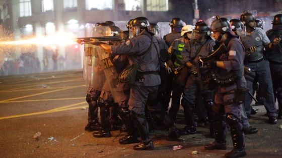 Riot cops firing tear gas or rubber bullets into crowd, Brazil, June 2013.