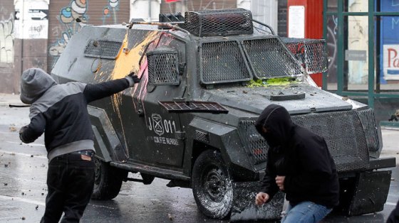 Militants in Chile attack police armoured car during mass student protests, June 2013.