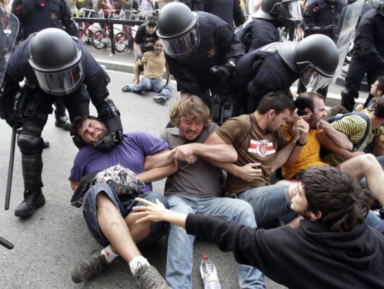 Participants in the Indignatas protests are assaulted by riot cops in Barcelona, 2011.