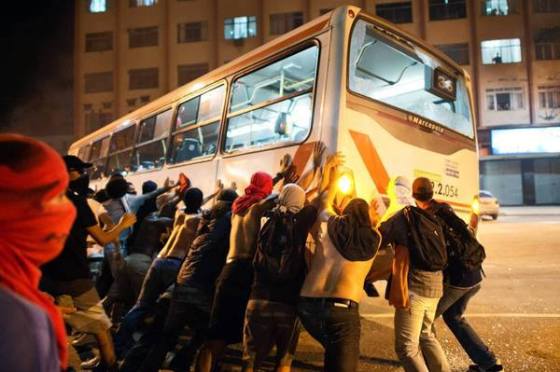 Brazil, June 20, 2013, protests.  Demonstrators in Niteroi, near Rio de Janeiro, overturn a bus during protests. Clashes with police continued even as bus fare hikes were rolled back in two cities after protests.