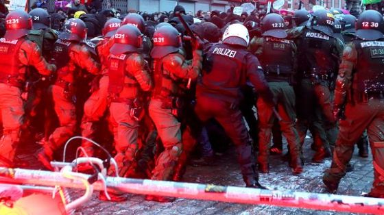 German riot cops attack a section of the march, Dec 21, 2013.