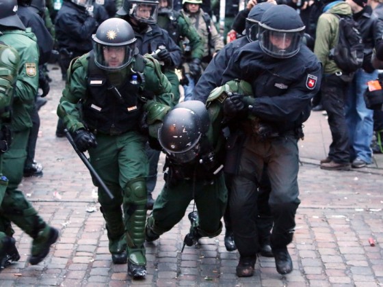 Officer Down: German riot cops carry their injured comrade during Rote Flora protest, Dec 21, 2013.